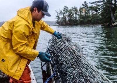 Samuel pulling oyster cages for Ferda Farms Oysters in Brunswick Maine