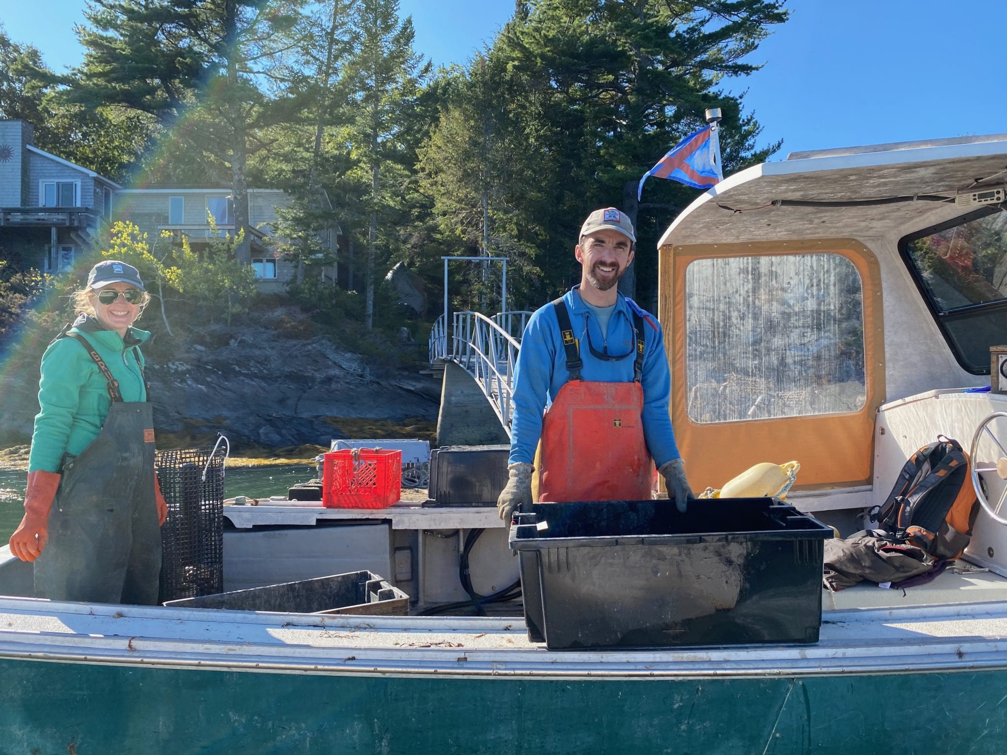 Mill Cove Oyster farmers on boat of New Meadows River, Maine